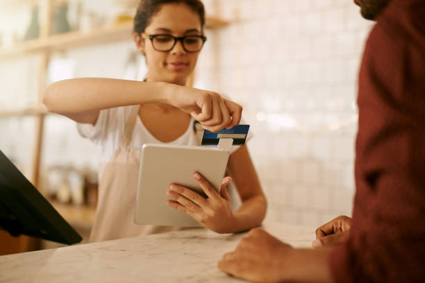 Cropped shot of a young woman accepting a card payment